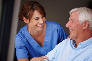 Dental assistant talking with patient.